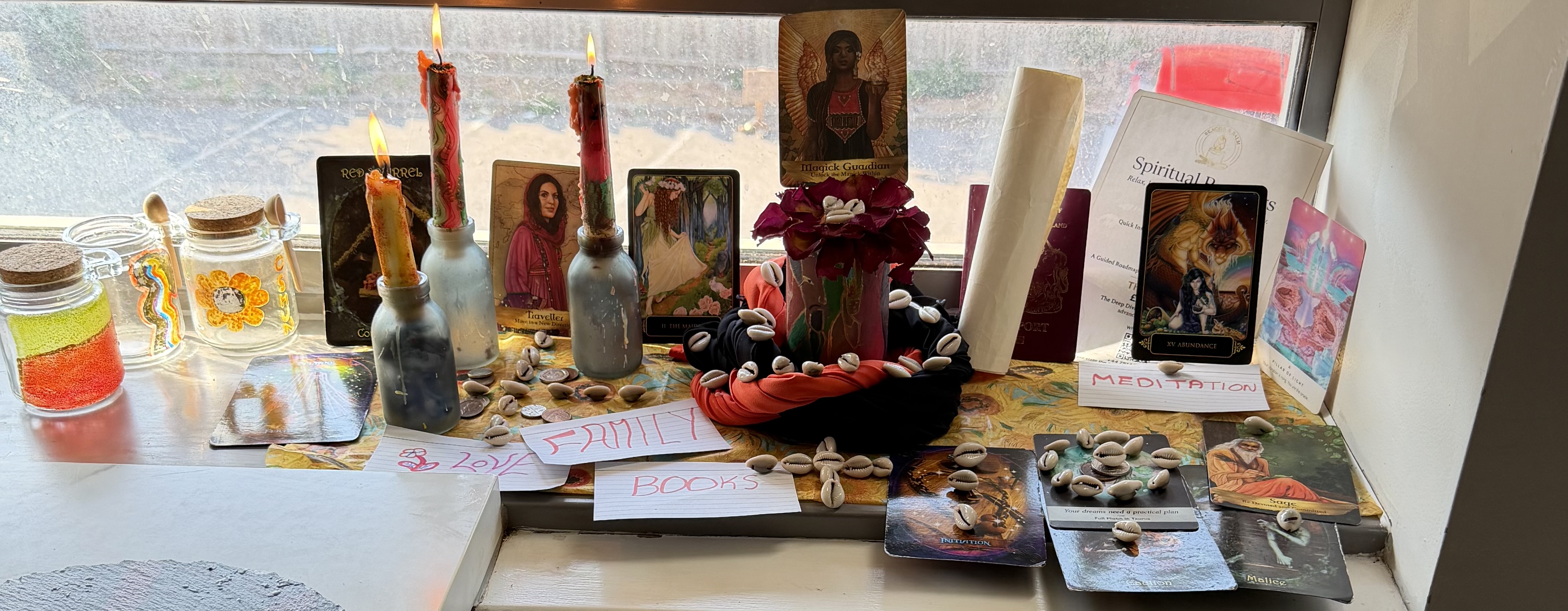 Farrah Thomas’s real display of candles, cowrie shells, cards and spiritual materials arranged beside a window