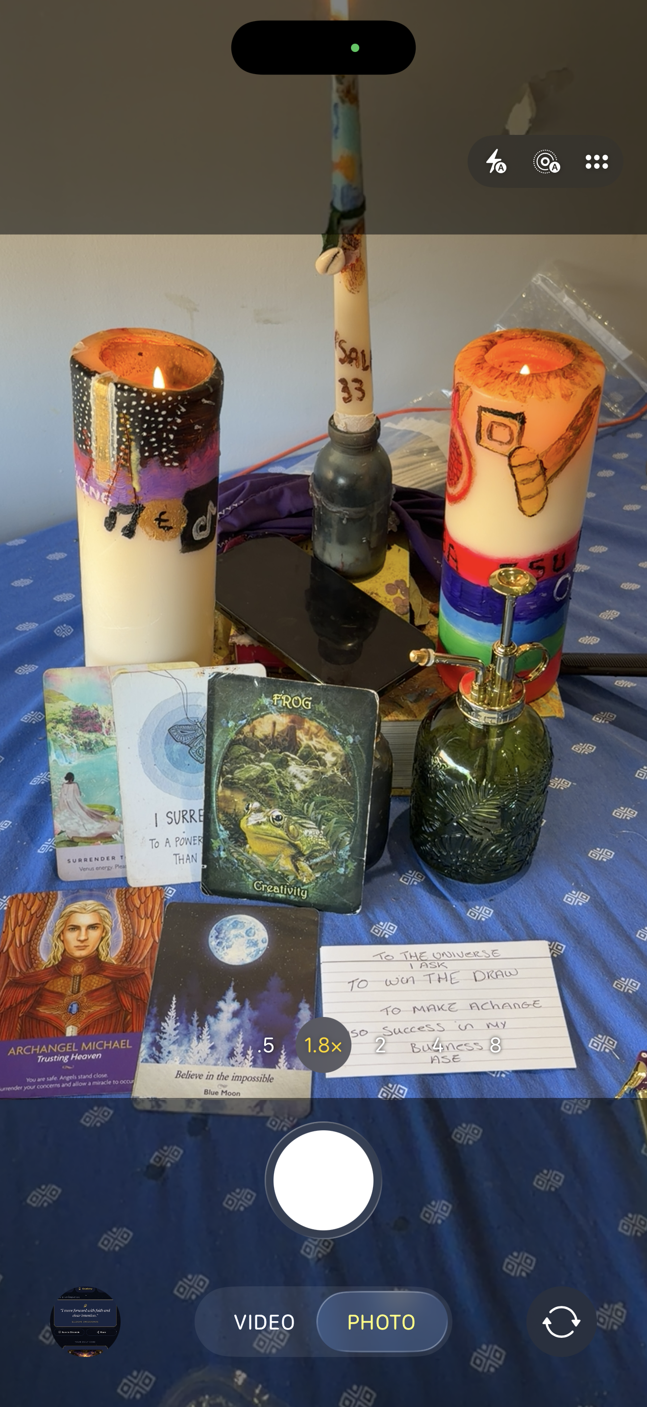 Real candlelit spiritual arrangement with candles and flowers, photographed by Farrah Thomas