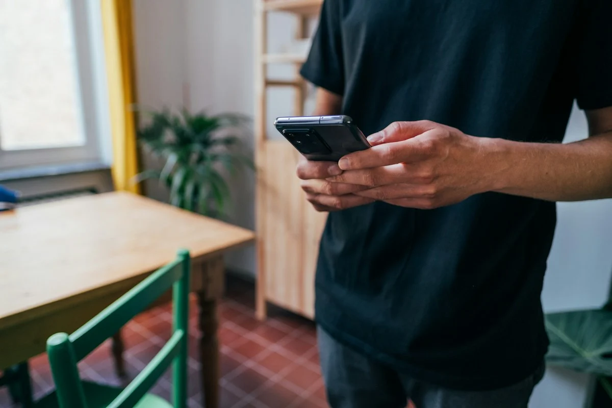 Illustrative stock photograph of hands holding a smartphone